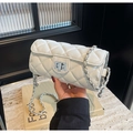 White quilted cylindrical pillow bag with silver turn-lock and woven chain strap - White