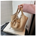 Minimalist beige bucket bag with lychee texture and matching mini pouch accessory - Khaki