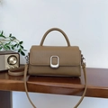 Brown leather crossbody bag with vintage metal buckle and textured pattern design - Brown