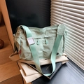 Mint green nylon crossbody dumpling bag with wide shoulder strap and drawstring detail - Green