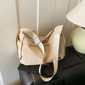 Minimalist beige nylon crossbody bag featuring a soft dumpling shape and wide shoulder strap - Off White