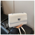 Detail of white crocodile embossed square bag with silver chain strap and metal lock buckle - White