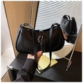 Detail showing high-quality black PU leather crescent bag with retro buckle and strap - Black