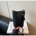 Detail of black bucket bag showing pebbled leather texture and adjustable strap - Pebble Grain Bucket Crossbody Style / Black