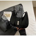 Detail of black glossy hobo bag with silver clasp on a grey suit jacket backdrop - No Pendant / Black