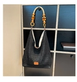Macro detail of hand-knitted black crochet mesh bag with wooden beaded handles - Black