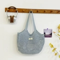 Light blue hand-woven mesh tote bag with a minimalist crochet design for summer travel - Blue