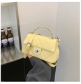 Detail of yellow quilted crossbody bag with silver twist lock and metal chain strap - Yellow