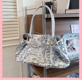 Detail shot of the shimmering silver sequin tote bag with metallic reflective texture - Silver