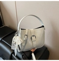 Detail of light gray bucket bag with metal buckles and pearl lace bow accessory - Blue with Charm