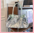 Detail showing shiny silver sequins and mint green leather handle on large tote bag - Green