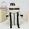Minimalist beige hiking backpack with multi-pocket design and black buckle straps - White