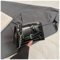 Detail of black glossy leather square bag with silver chains and buckle straps - Black