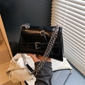 Glossy black leather crossbody bag with silver chain strap and metal buckles - Black