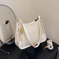Chic beige woven shoulder bag with metallic charms and adjustable strap - White