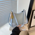 Light blue quilted shoulder bag with woven texture and elegant gold pendant - Blue