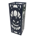 Close-up of black laser-cut Halloween candle cover with pumpkin and haunted house design - Halloween A