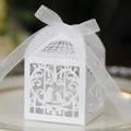 Detail of white laser-cut favor box with pearlescent finish and organza ribbon bow - Double Birds Vines Style (XTH-30)