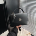 Classic black matte leather handbag with adjustable strap and circular metal lock buckle - Black (Without Charm)