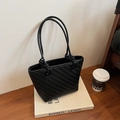 Minimalist black woven bucket tote bag with chevron texture and knotted shoulder straps - Black