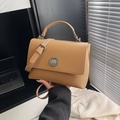 Vintage brown leather crossbody bag with silver twist lock shown in a lifestyle setting - Khaki (Without Charm)