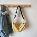 Minimalist light yellow dumpling crossbody bag with adjustable black strap on wooden hanger - Yellow Without Pendant