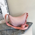 Pink and white checkered crescent crossbody bag with adjustable striped shoulder strap - Pink