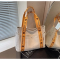 Detail of beige canvas tote bag with orange floral strap and metal magnetic buckle closure - Rice White & Orange