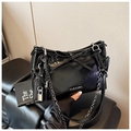 Detail of glossy black leather tote with bow knot, metal chain strap and logo - Black