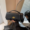 Minimalist black square handbag with golden twist lock and textured leather finish - Black & Gold
