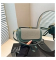 Detail view of the vintage contrast leather and canvas stitching on a chic crossbody bag - Green