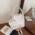 Chic beige lychee grain bucket bag with cute elephant charm and leather details - Off White