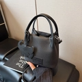 Black litchi grain leather mini bucket bag with leather elephant charm and shoulder strap - Black