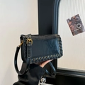 Chic black woven square shoulder bag with metal grommets and adjustable strap - Black