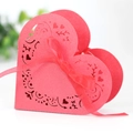 Detail of red heart laser-cut candy box with intricate floral patterns and matching ribbon - Pearlescent Red