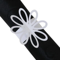 Detail showing white laser-cut floral paper napkin ring on black silk cloth - White