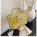 Yellow quilted leather bucket bag with metallic chain handle and floral hardware - Yellow