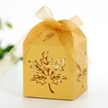 Detailed view of hollow maple leaf paper candy gift box with golden ribbon bow decoration - Gold