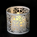 White hollow paper lantern with LED candle showing intricate laser-cut floral patterns - White