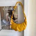 Minimalist bright yellow crescent crossbody bag with colorful beaded charm and pleat detail - Yellow with Pendant