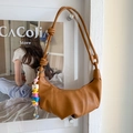 Detail of brown pleated dumpling bag with adjustable strap and colorful SUNS charm - Brown with Pendant