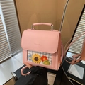 Pink faux leather backpack featuring a transparent window with knit floral decorations - Pink