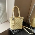 Pale yellow quilted bucket bag with leather star charms and adjustable strap - Yellow