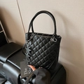 Chic black quilted tote bag with star charms and adjustable shoulder strap - Black