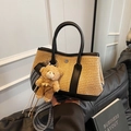 Contrast straw bucket bag with black leather trim and a cute plush bear pendant accessory - Black with Pendant