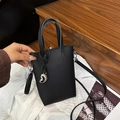 Mini black lychee leather crossbody bag with heart pendant and adjustable strap - Black