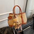 Contrast straw bucket bag with tan leather handles, teddy bear charm, and patterned strap - Brown with Pendant