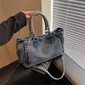 Blue washed denim tote bag with dual handles and adjustable strap on leather seat - Light Blue