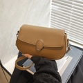 Minimalist tan brown leather saddle shoulder bag with litchi grain and metal buckle - Brown