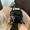 Mini black patent leather backpack with pearl heart charm and glossy finish - Black with Pendant